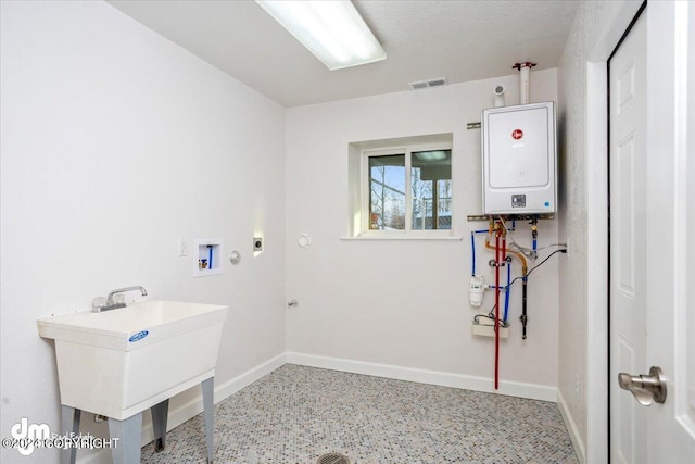 laundry area with hookup for a gas dryer, hookup for a washing machine, and water heater