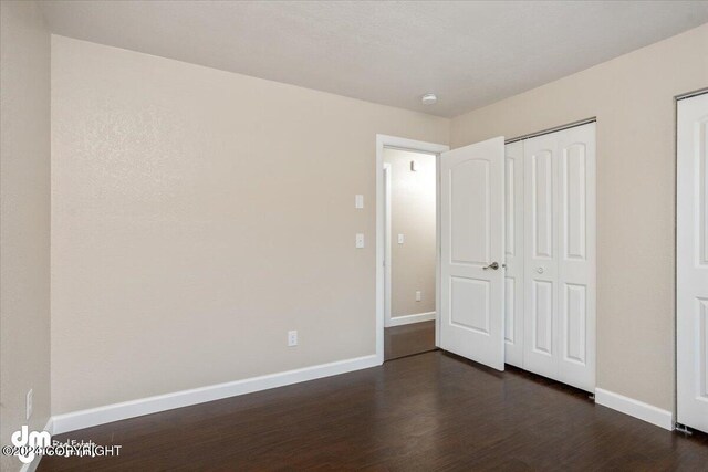 unfurnished bedroom featuring dark hardwood / wood-style floors