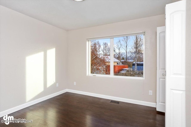 empty room featuring dark hardwood / wood-style flooring