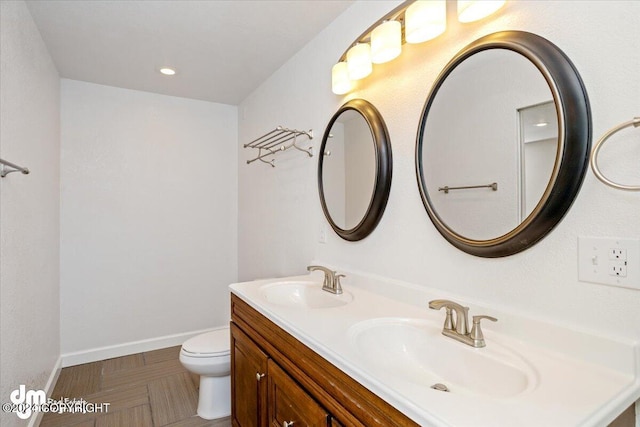 bathroom featuring toilet and vanity