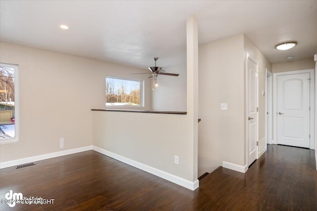 unfurnished room featuring dark hardwood / wood-style floors and ceiling fan