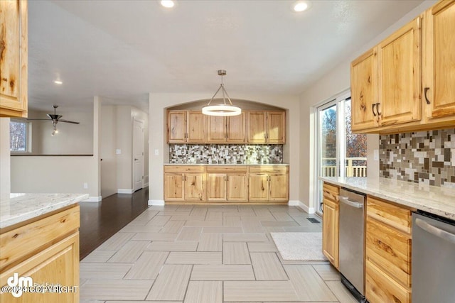 kitchen with tasteful backsplash, dishwasher, light wood-type flooring, decorative light fixtures, and light stone counters