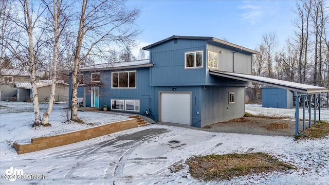 view of front of house featuring a storage shed and a garage