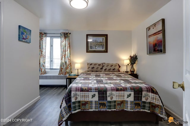 bedroom featuring dark hardwood / wood-style flooring and radiator heating unit