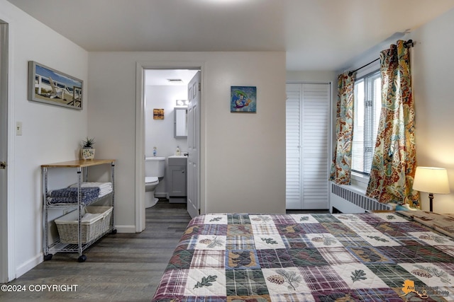 bedroom with dark wood-type flooring and ensuite bathroom