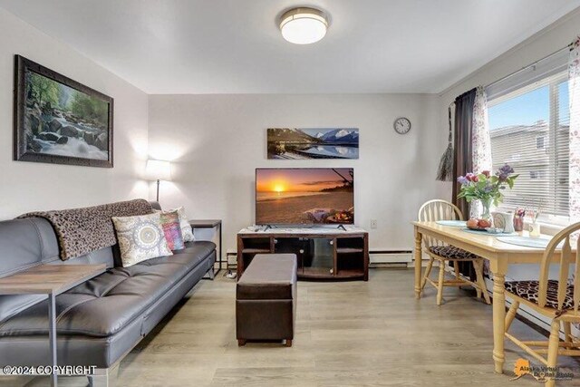 living room featuring a baseboard radiator and light wood-type flooring