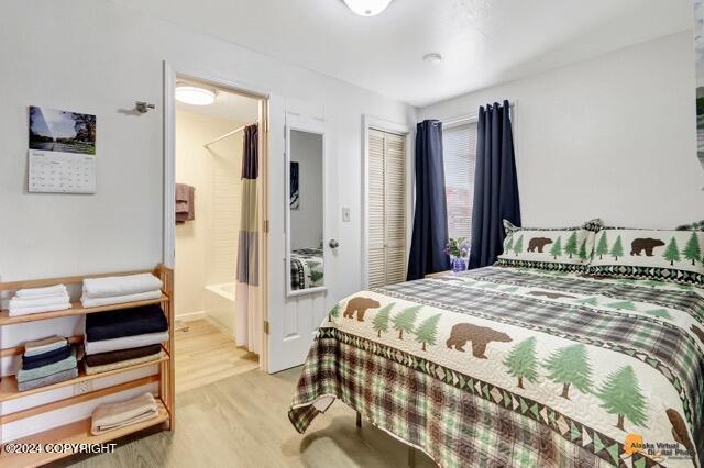 bedroom with light wood-type flooring and a closet