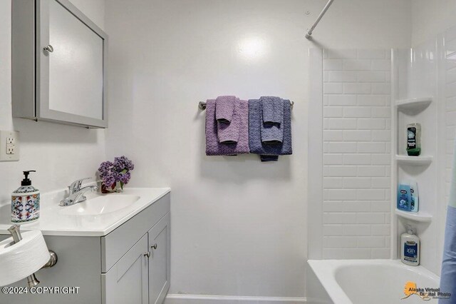 bathroom with vanity and tiled shower / bath