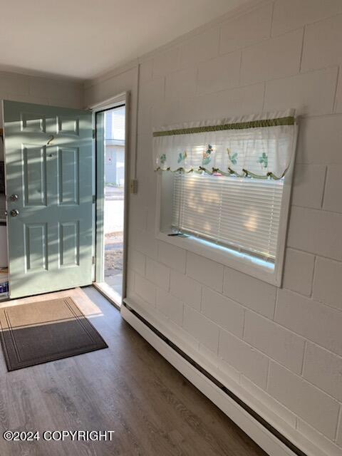 interior space featuring hardwood / wood-style floors and a baseboard heating unit