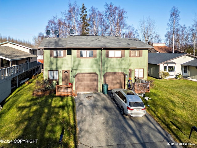 view of front of property with a garage and a front lawn