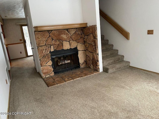 unfurnished living room featuring a stone fireplace, vaulted ceiling, and carpet