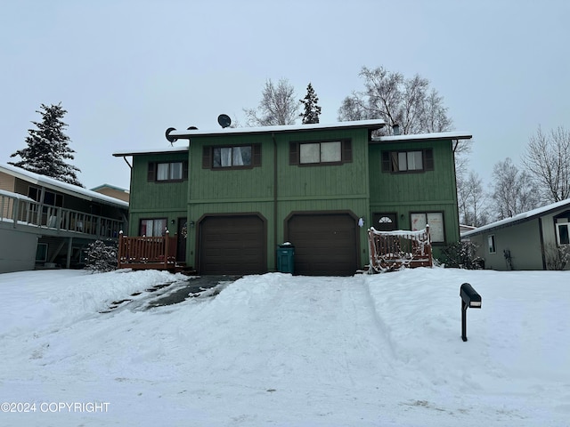 view of front facade with a garage and a wooden deck