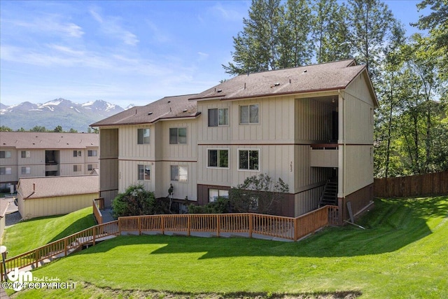 exterior space with a mountain view and a lawn