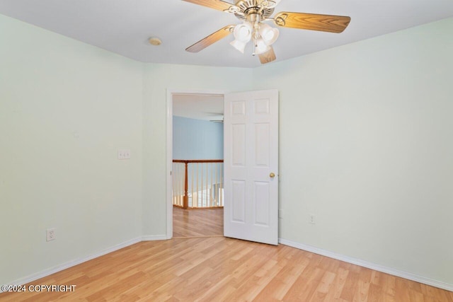 spare room featuring light hardwood / wood-style floors and ceiling fan