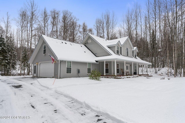 cape cod home featuring a garage and a porch