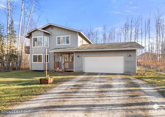 view of property with a front yard and a garage