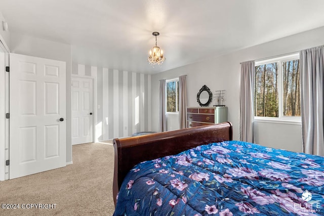 carpeted bedroom with a notable chandelier