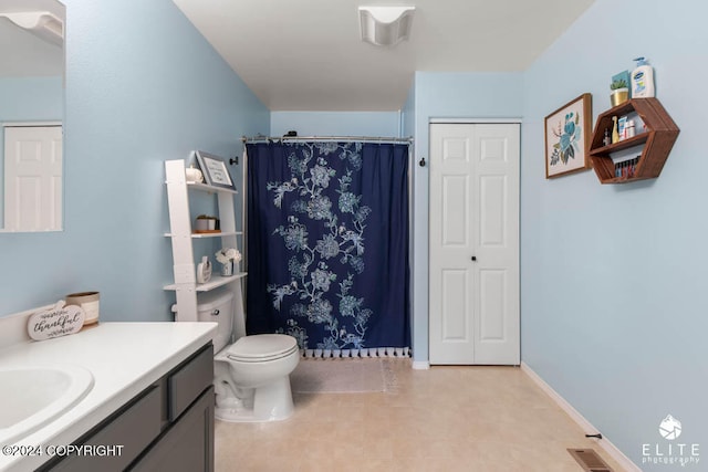 bathroom featuring tile patterned flooring, vanity, and toilet