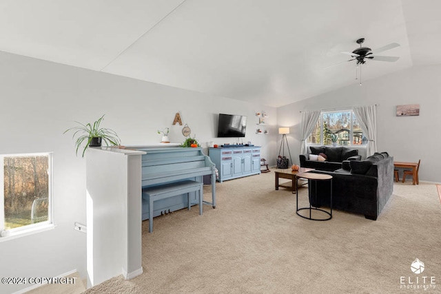 carpeted living room featuring ceiling fan and vaulted ceiling