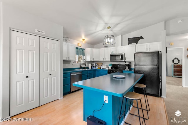 kitchen featuring black appliances, hanging light fixtures, a kitchen island, blue cabinets, and white cabinets