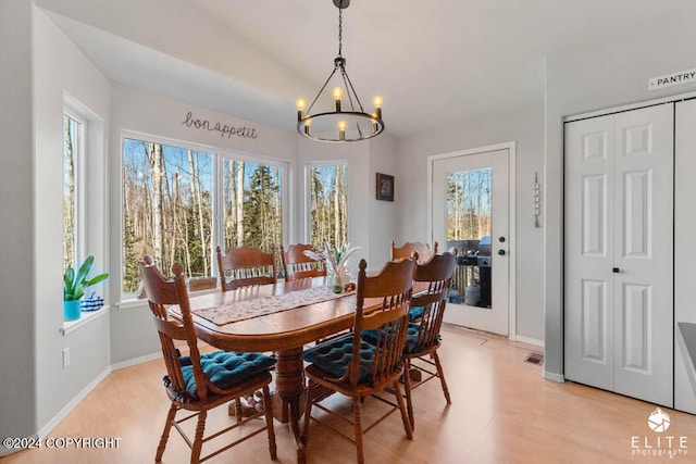 dining room with a notable chandelier and light hardwood / wood-style floors