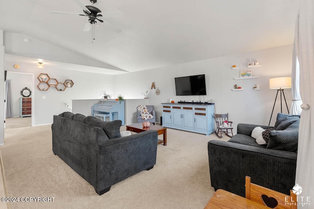 living room with ceiling fan, light carpet, and lofted ceiling