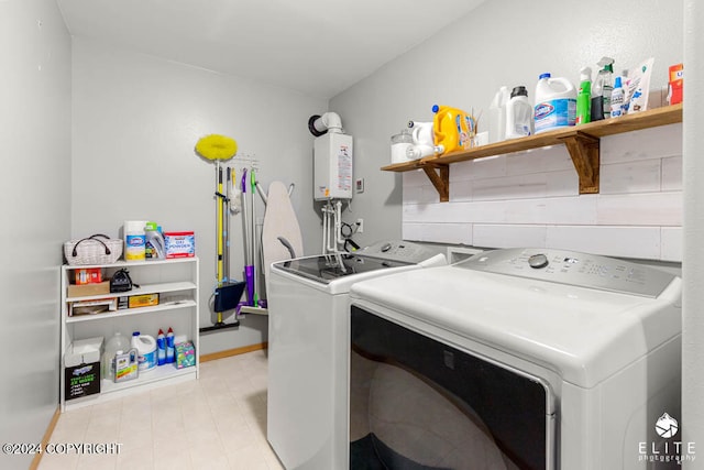 laundry room with water heater and washer and dryer