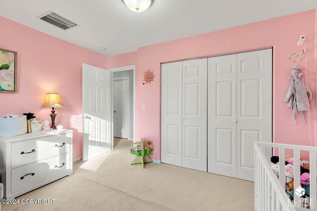 bedroom featuring light carpet and a closet