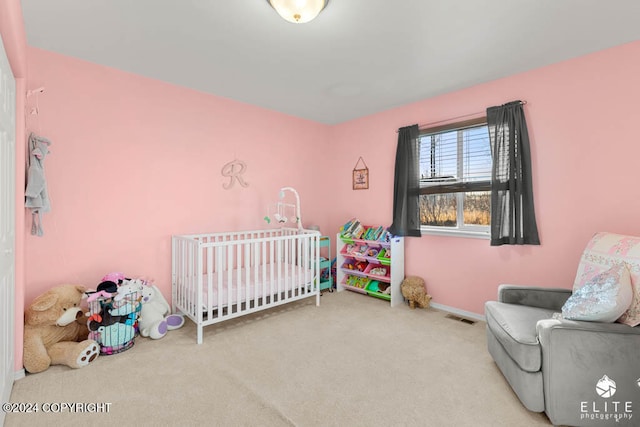 bedroom featuring a crib and light carpet