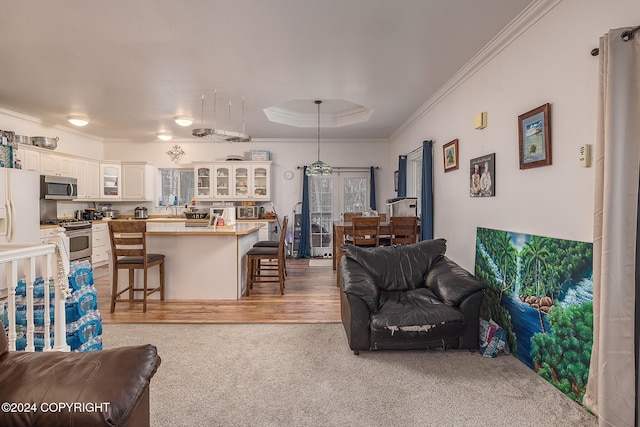 living room with ornamental molding and light carpet