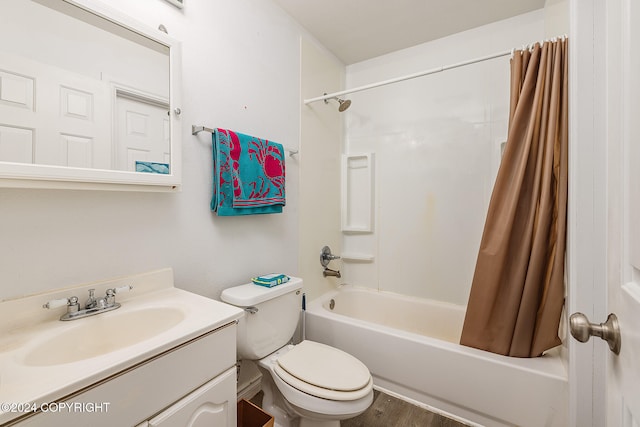 full bathroom with shower / bath combo, vanity, hardwood / wood-style flooring, and toilet