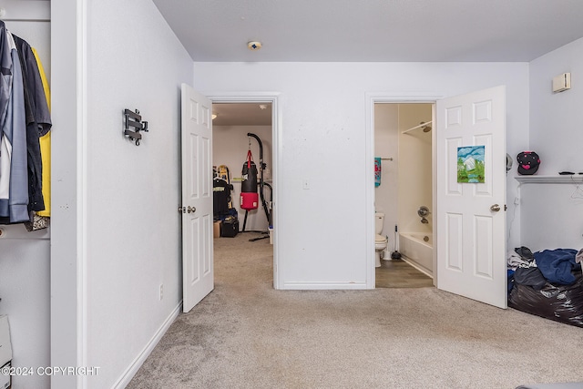 bedroom with light carpet and connected bathroom