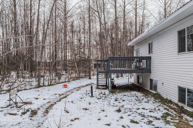 yard covered in snow featuring a wooden deck