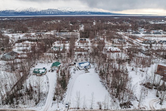 snowy aerial view with a mountain view