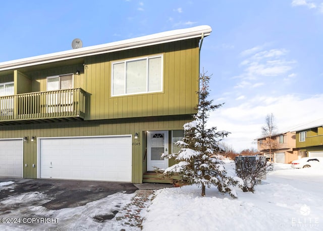 multi unit property featuring a garage and a balcony