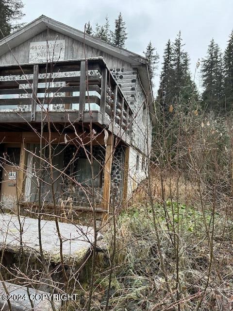 view of side of home with a deck