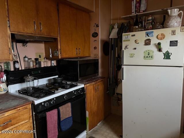 kitchen with white appliances and exhaust hood