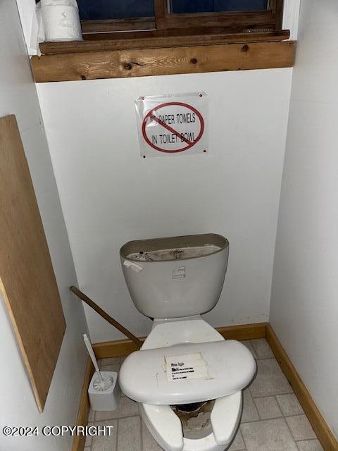 bathroom featuring tile patterned flooring and toilet