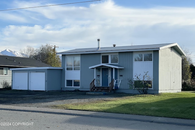 4312 E 6th Ave, Anchorage, AK 99508 - view of front of property featuring a front lawn, entry steps, a garage, and an outdoor structure