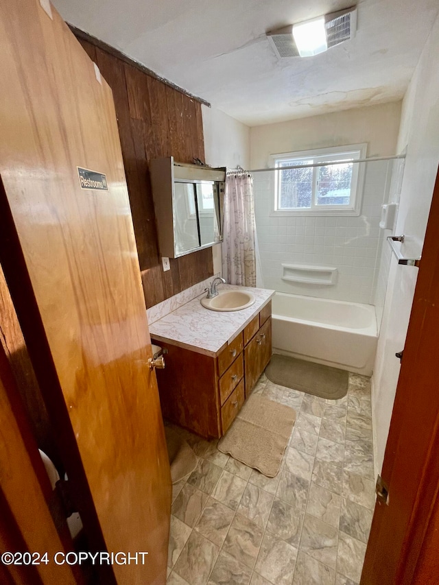 bathroom with shower / bath combo with shower curtain and vanity