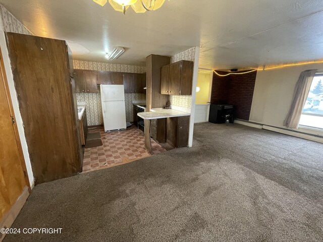4312 E 6th Ave, Anchorage, AK 99508 - kitchen with freestanding refrigerator, light countertops, a baseboard radiator, and carpet