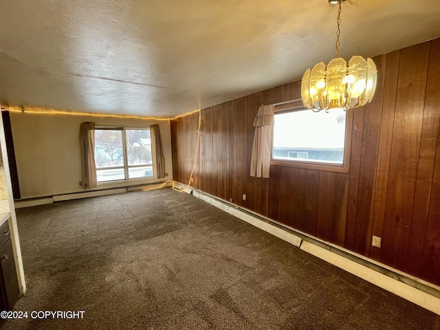 4312 E 6th Ave, Anchorage, AK 99508 - carpeted spare room with a chandelier, wood walls, and healthy amount of natural light