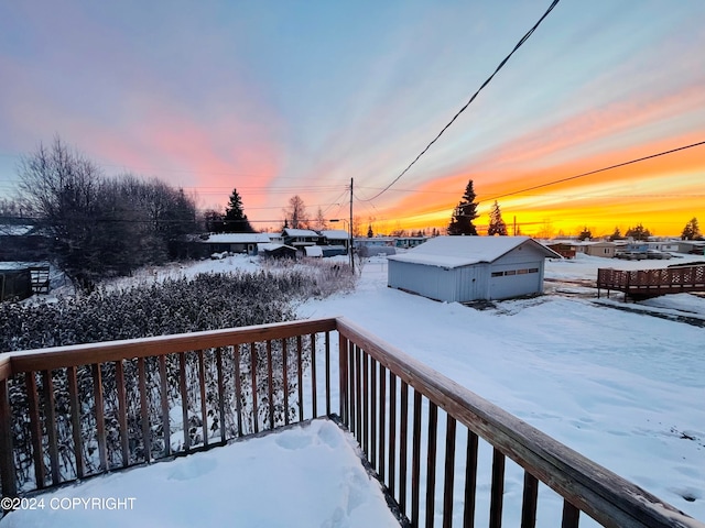 snow covered deck with a garage