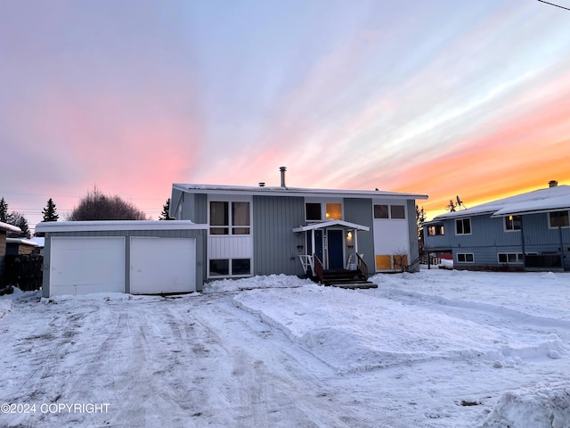 4312 E 6th Ave, Anchorage, AK 99508 - snow covered back of property featuring a garage