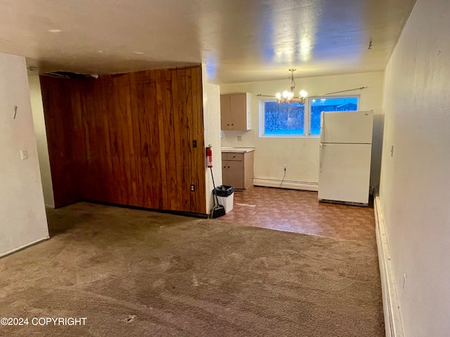 kitchen featuring pendant lighting, light colored carpet, a baseboard radiator, and white refrigerator