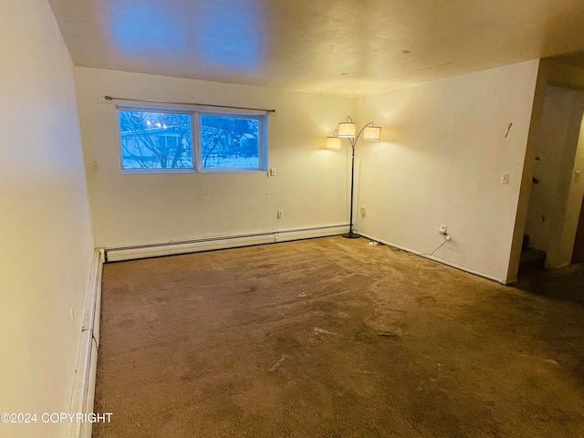 carpeted empty room with baseboard heating