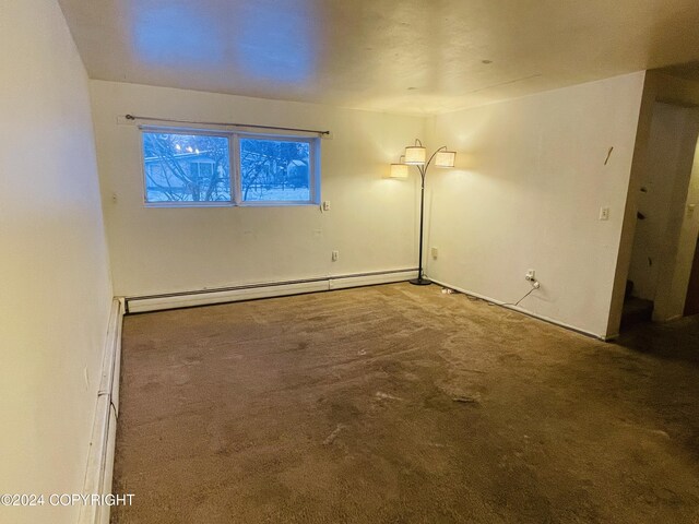 4312 E 6th Ave, Anchorage, AK 99508 - carpeted empty room with a baseboard heating unit