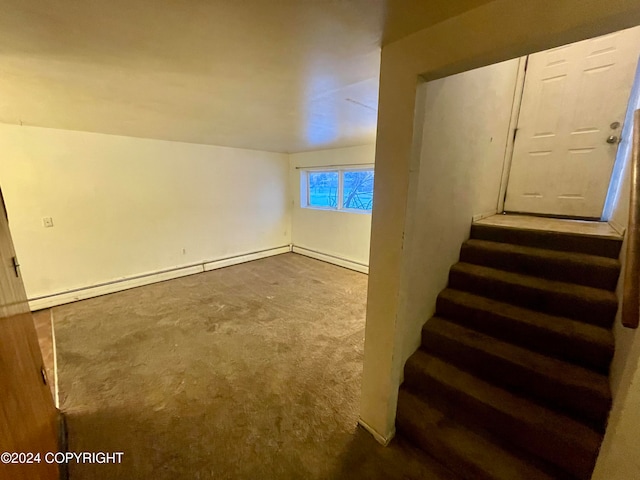 staircase with carpet flooring, lofted ceiling, and a baseboard heating unit