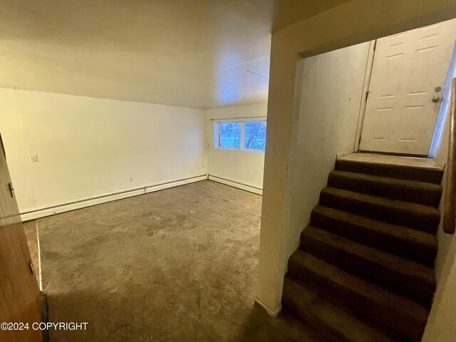 4312 E 6th Ave, Anchorage, AK 99508 - below grade area with carpet, stairway, and baseboard heating