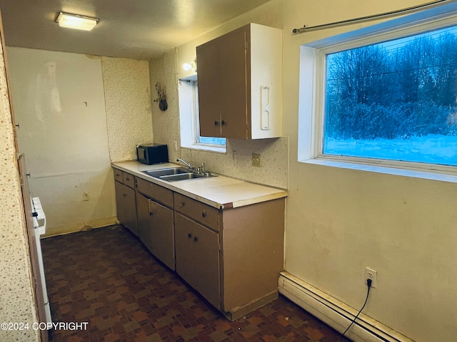 kitchen featuring sink and a baseboard heating unit